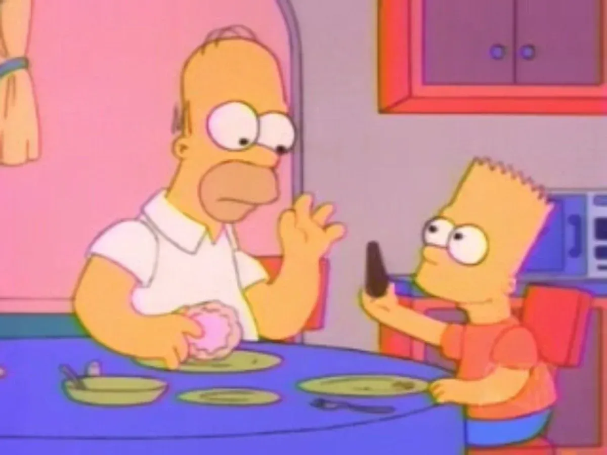 Homer and Bart at the kitchen table, Homer holding a doughnut and Bart an ice lolly